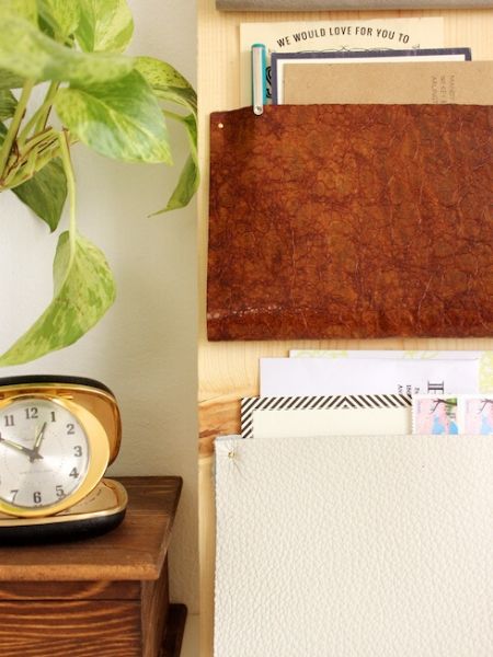 Leather organizer on the desk with desk table and plant beside it